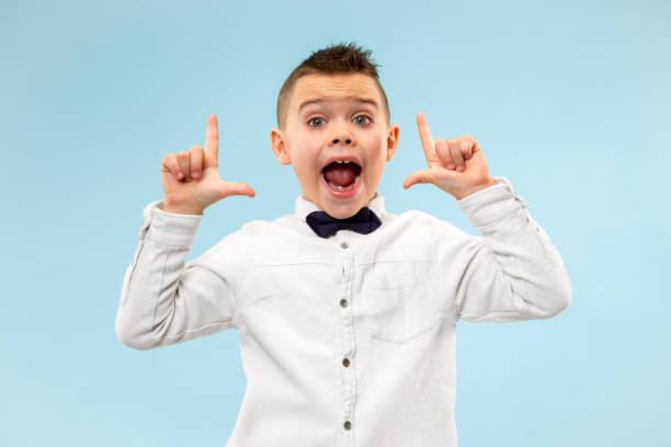istock Isolated on blue young casual boy shouting at studio 1127531025