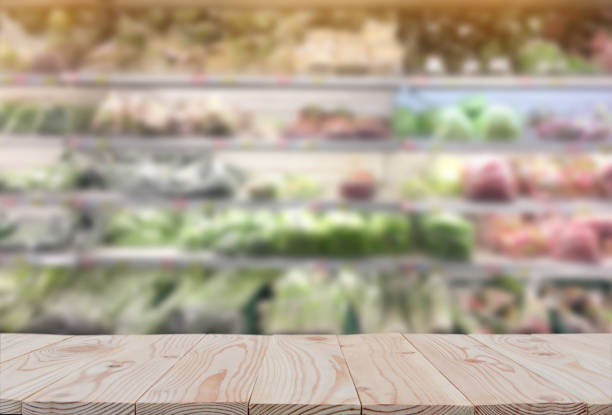 istock Empty wooden board table top on of blurred supermarket background. with copy space for display or montage your products 1127531469