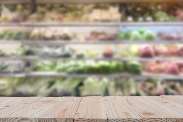 istock Empty wooden board table top on of blurred supermarket background. with copy space for display or montage your products 1127531507