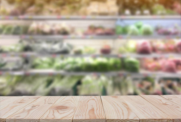istock Empty wooden board table top on of blurred supermarket background. with copy space for display or montage your products 1127531761