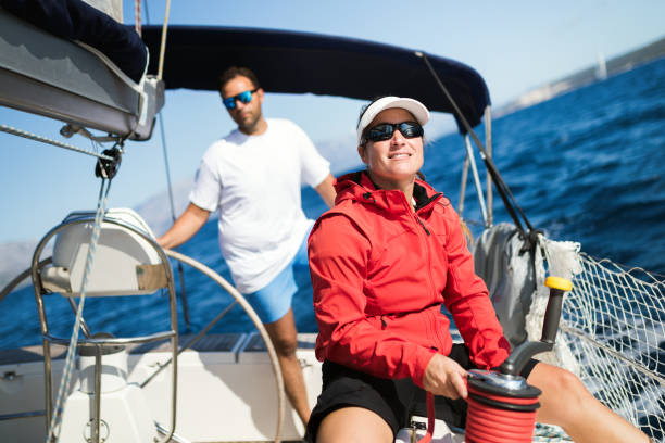 istock Attractive strong woman sailing with her boat 1127532036