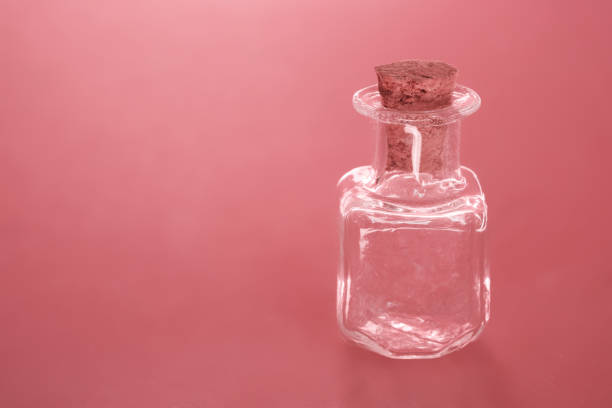 istock Empty small bottle with a cork on a living coral background with an empty inscription copy space. soft light 1127532087