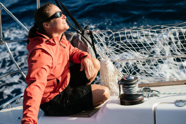 istock Attractive strong woman sailing with her boat 1127532142