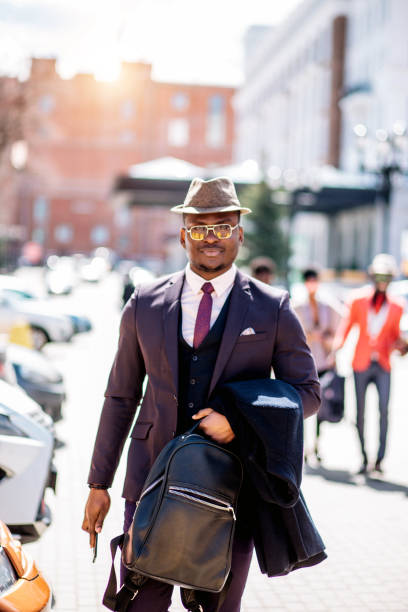 istock stylish black guy in hat looking at the camera 1127533249