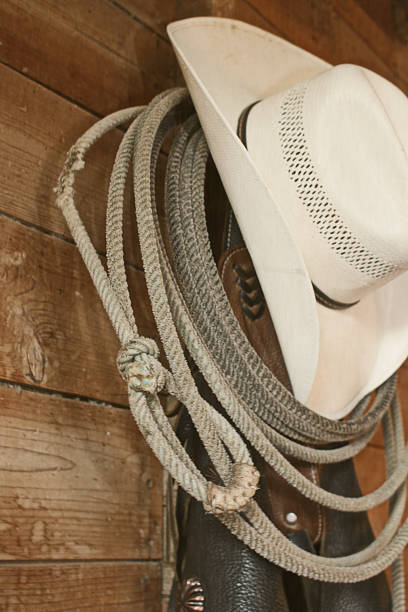 istock Cowboy hat and lasso hanging in the barn 1127533321