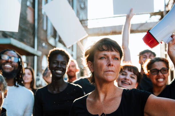 istock Feminist with a megaphone at a protest 1127533964