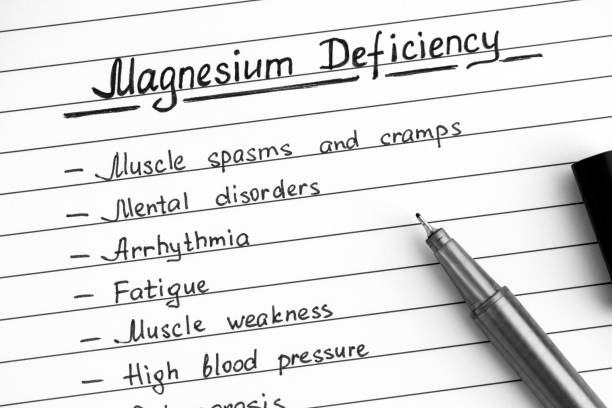 Symptoms of Magnesium Deficiency writing on list with black pen. Symptoms of Magnesium Deficiency writing on list with black pen. Close-up. magnesium deficiency stock pictures, royalty-free photos & images