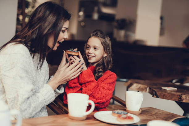 istock Mama and daughter heaving breakfast in cafe 1127536715