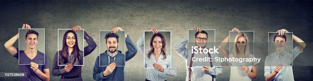 Group of happy smiling people Happy group of multiethnic people men and women holding self portraits Human Face Stock Photo