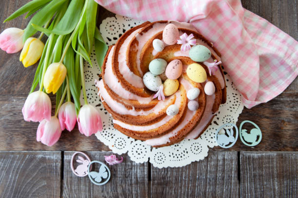 Yummy bundt cake with frosting Yummy bundt cake with easter eggs and pink frosting easter cake stock pictures, royalty-free photos & images