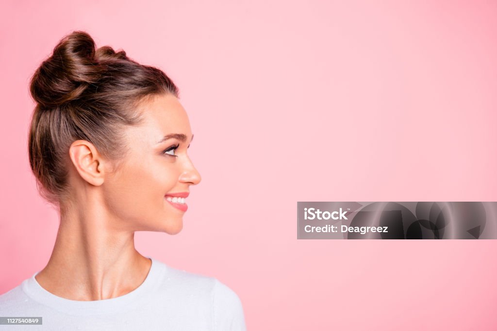 Close-up profile side view of nice lovely cute fascinating attractive groomed cheerful cheery girl looking aside copy empty blank space place isolated over pink pastel background Women Stock Photo