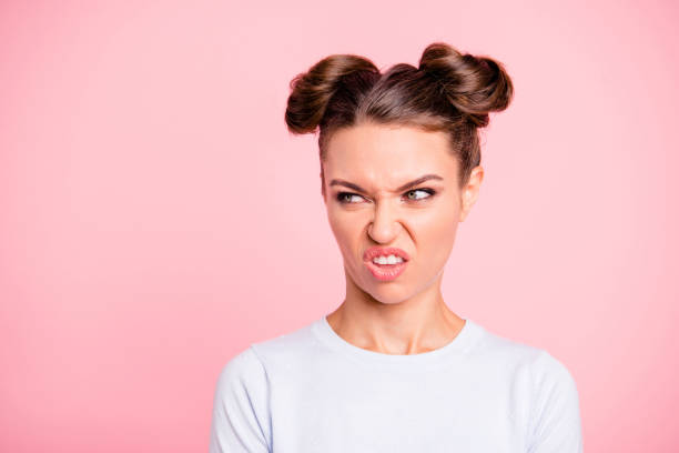 close-up portrait of nice lovable attractive well-groomed modern angry girl looking at ugly object isolated over pink pastel background - offense imagens e fotografias de stock