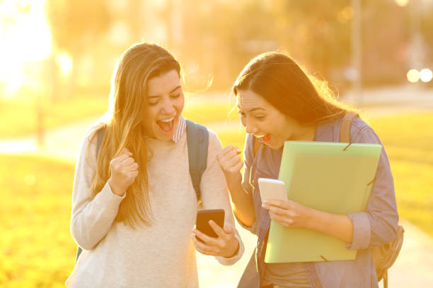 istock Excited students finding good news online at sunset 1127542214