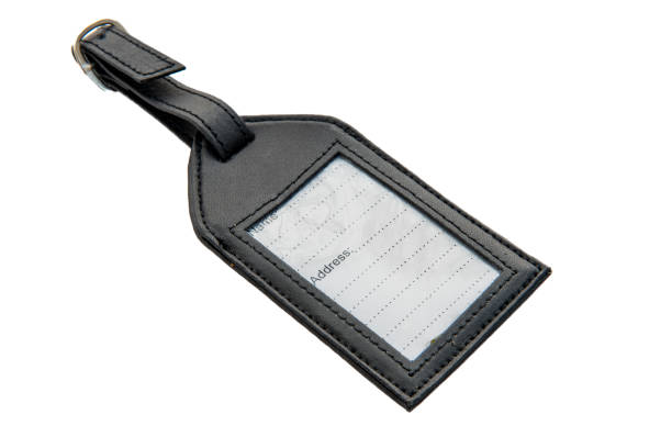 istock Old-fashioned leather luggage tag with blak label. 1127542307