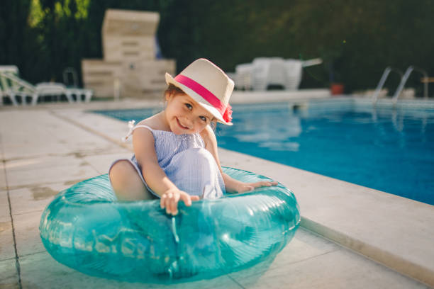 istock Cheerful little girl by the pool 1127542655