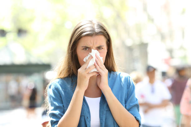 istock Ill woman blowing mucus looking at camera 1127542816