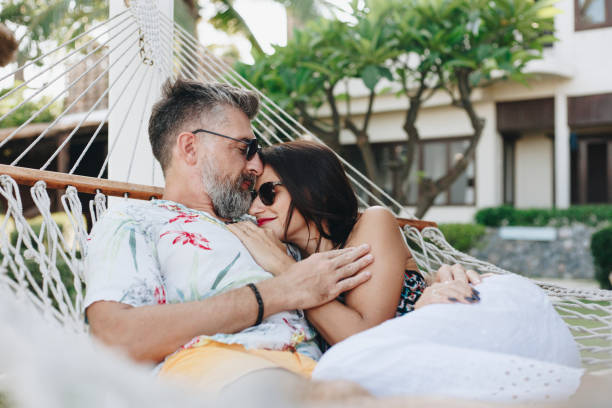 istock Couple resting together in a hammock 1127543207