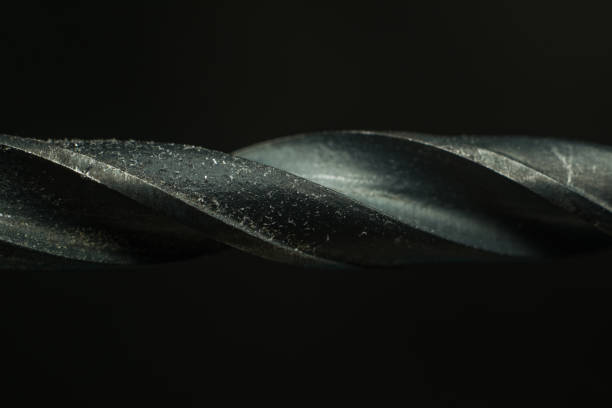 Close-up of a metal drill bit on black background stock photo