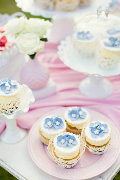 istock cupcakes with cream and flower decorations 1127544055