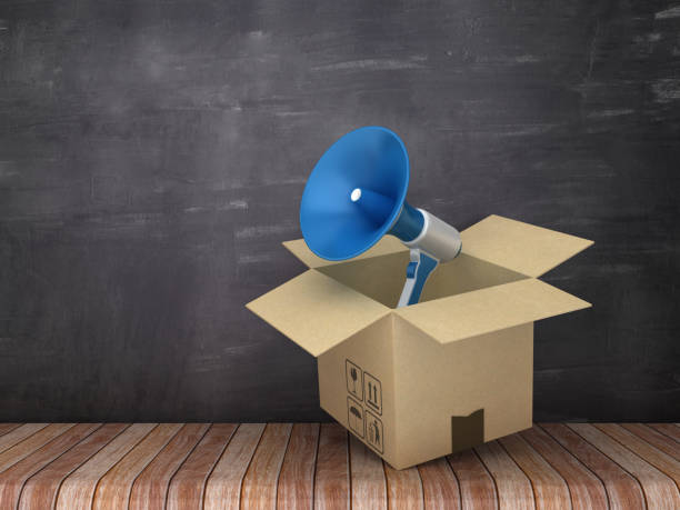 istock Cardboard Box with Megaphone on Wood Floor - Chalkboard Background - 3D Rendering 1127544555