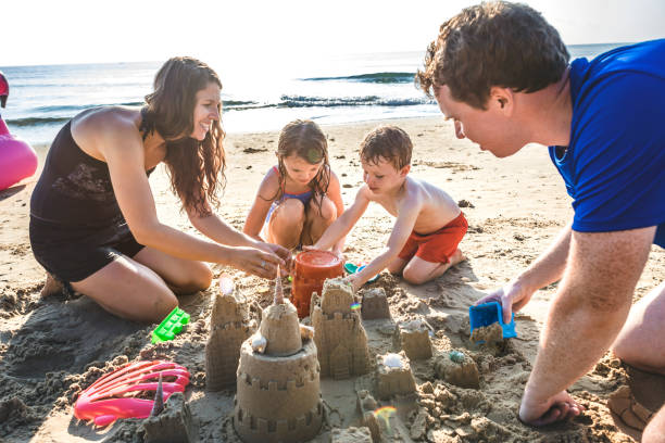 istock Family playing on the beach 1127544567