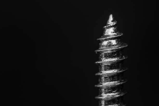 Close-up of a metal screw on a black background stock photo