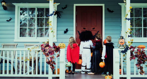 istock Little children trick or treating 1127546623