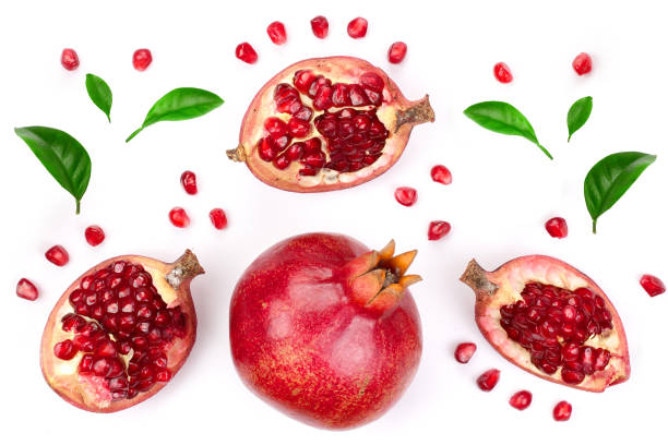 istock pomegranate with leaves isolated on white background. Top view. Flat lay pattern 1127546977