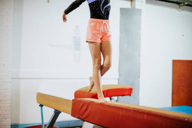 istock Young gymnast on a balance beam 1127548271
