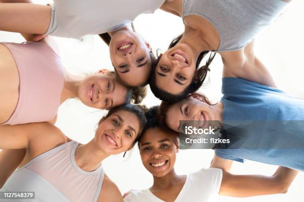 Excited Girls Hug At Training Involved In Motivational Activity Stock Photo - Download Image Now
