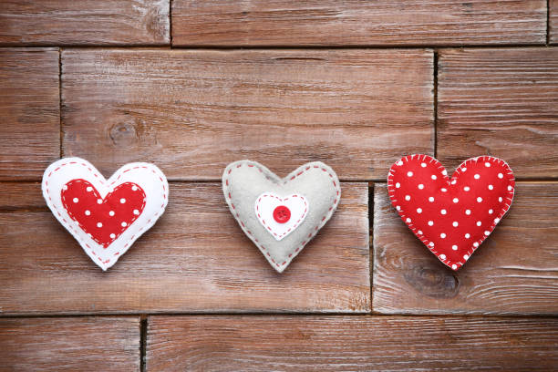 istock Fabric hearts on brown wooden table 1127548977