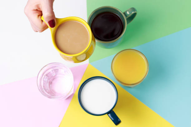 istock Coffee tea and other drinks in colorful cups on a white background, top view 1127549258