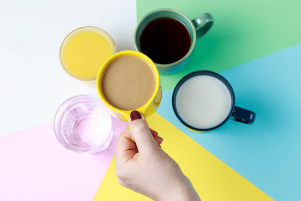 istock Coffee tea and other drinks in colorful cups on a white background, top view 1127549289