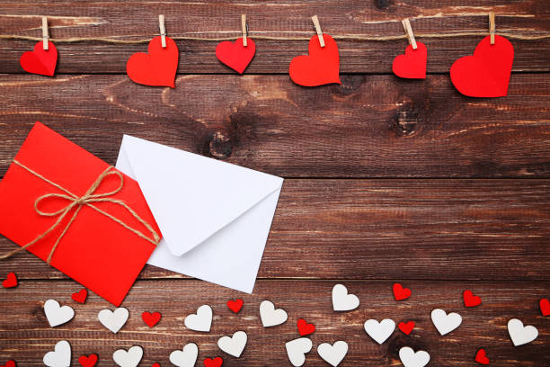 istock Paper hearts with envelopes on brown wooden table 1127549415