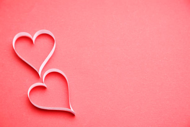 istock White paper hearts on red background 1127549438