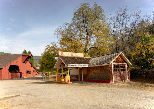 Vintage, restored Shell Station and barn at the South Yuba River State Park, California, USA, in the autumn, featuring yellow colors of leaves