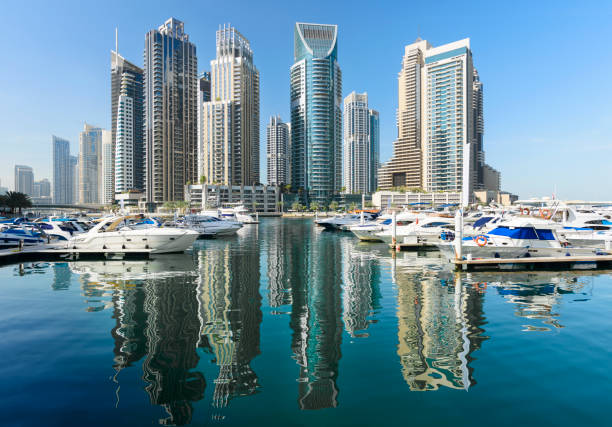 Skyscrapers and Moored Boats at Dubai Marina , United Arab Emirates Reflections in the Still Marina Waters dubai marina panorama stock pictures, royalty-free photos & images