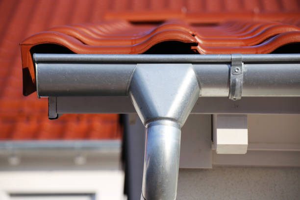 istock Roof gutter on a new tiled roof 1127550628