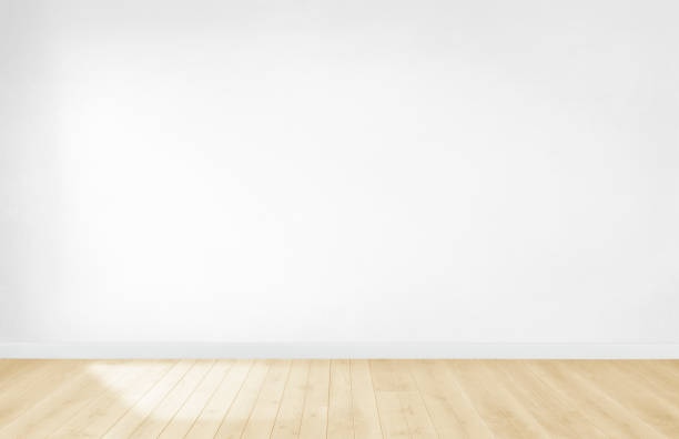 istock White wallpaper in an empty room with wooden floor 1127550673