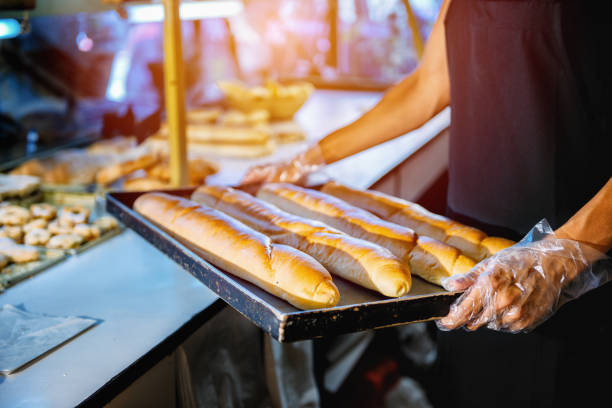 istock Midsection Of Young Woman Working At Bakery 1127550700