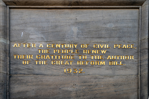 Inscription at the base of Grey's monument in Newcastle upon Tyne. Earl Grey as well as having a tea named after him was a great reformer of English law and suffrage and principle architect of the 1832 Reform act.