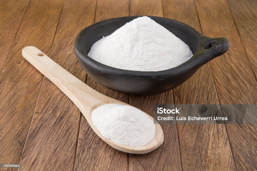 Baking soda (sodium bicarbonate) in a wooden spoon Alkaline Stock Photo