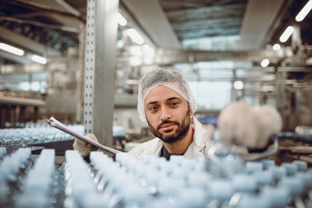 istock Bearded Quality Control Inspector At Bottling Plant 1127552819