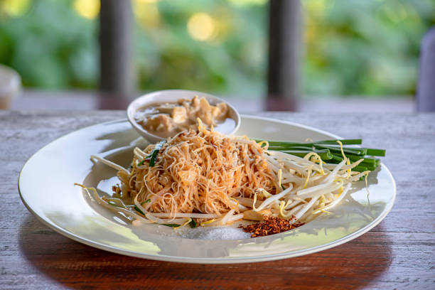 istock Fried noodle with spring onion and bean sprouts on white plate with garnish. 1127553002
