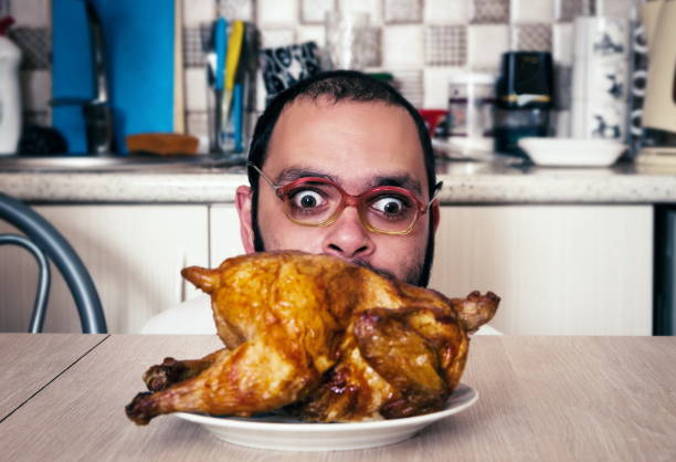 istock Man Looking At Roasted Chicken In Kitchen At Home 1127553265