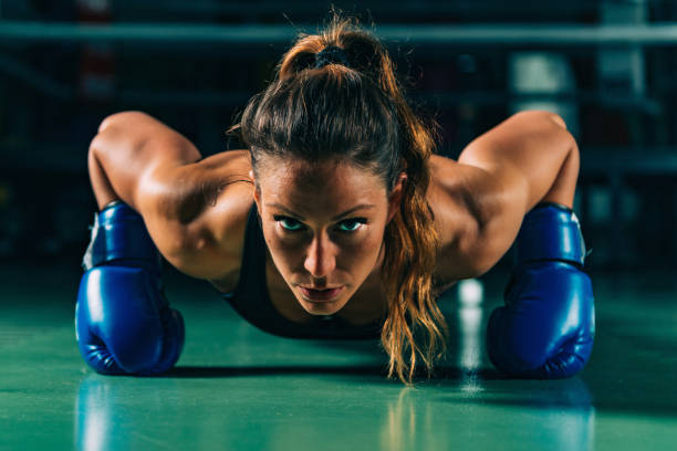 portrait d’un athlète faisant des pompes au gymnase - athlete push ups muscular build female photos et images de collection