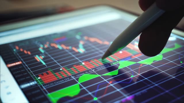 Businessman Analyzing at graph of Stock Market Data,Close-up