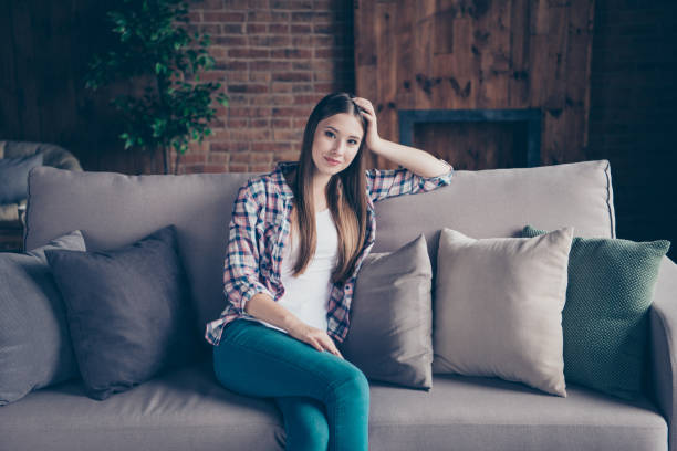 istock Pretty sweet peaceful charming attractive tranquil nice glad optimistic she her lady having rest on classic beige divan looking at camera 1127554336