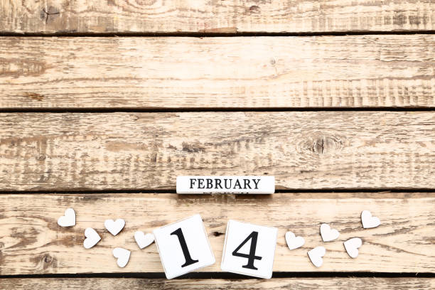 istock Valentine day on wooden blocks with white hearts 1127554709