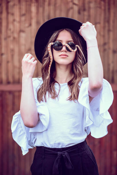istock Young Fashionable Female Posing With Her Pet Snake 1127555148